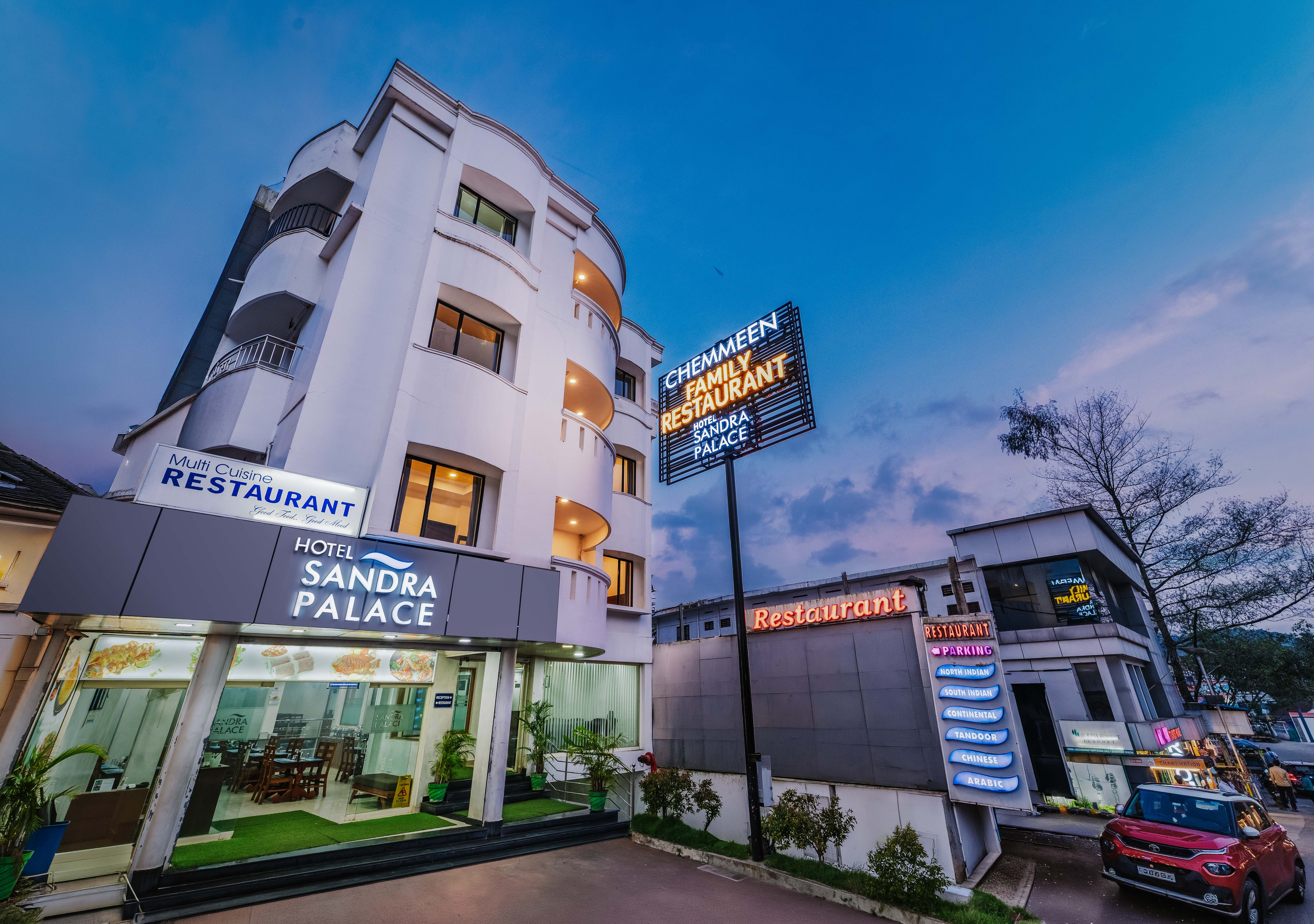 Hotel Sandra Palace at Thekkady Junction, lit at dusk